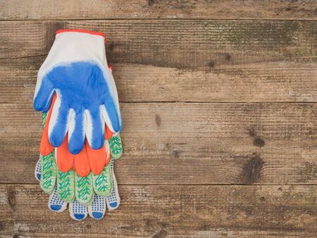 Protective gloves painter on wooden background. The view from the top.