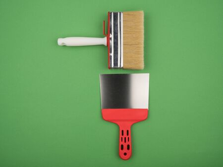 The big red brush and spatula on a green background. The view from the top.の写真素材