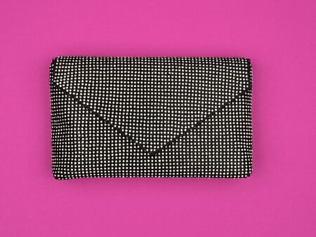 Womens stylish clutch on a bright pink background.の写真素材