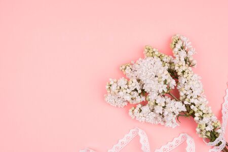 Spring bouquet and lace on pink background. White lilac.の写真素材