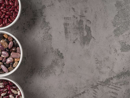 Three kinds of beans closeup on grey background.の写真素材