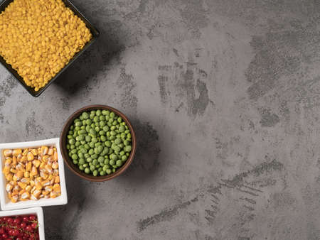 Red, yellow, and green ingredients for cooking. Beans on a grey background.の写真素材