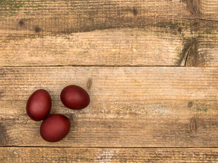 Painted eggs on a wooden background. View from above.の写真素材
