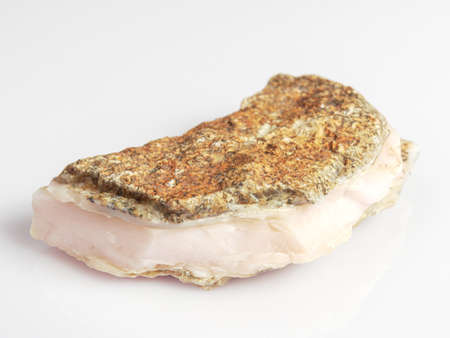 Calcite pink on a white background. Untreated natural stone.の写真素材