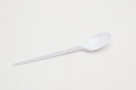 Plastic disposable spoon on a white background.の写真素材