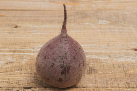 A Fresh and Vibrant Display of Beetroot Beautifully Arranged on a Rustic Wooden Backgroundの写真素材
