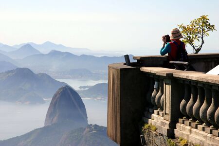 Tourist taking picture of the Sugar Loaf in Rio de Janeiroの写真素材