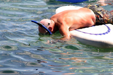 A tourist snorkeling from floating mattress