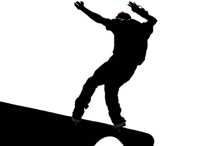 Male skateboarder jumps on a concrete edge at a skateboard park. の写真素材
