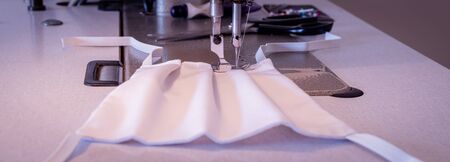 Manufacture of washable masks for face protection against viruses, allergies, epidemics and global pandemics.の写真素材