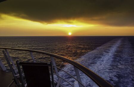 Sunset in the wake of a cruise ship.の写真素材