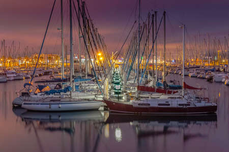 Sailboats in a port in the south of France. Boats moored to pontoons.