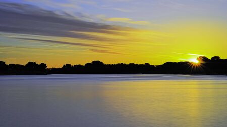 Sunset over a pond.の写真素材