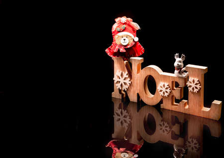 Wooden Christmas decorations with black reflection and space for text.の写真素材