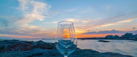 Sunset over La Grande Motte, Herault, France. Stemmed glasses.