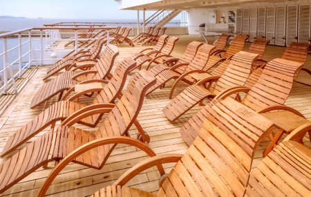 View of the upper deck and deckchairs of a cruise ship.の写真素材