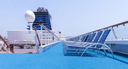 View of the upper deck and deckchairs of a cruise ship.の写真素材