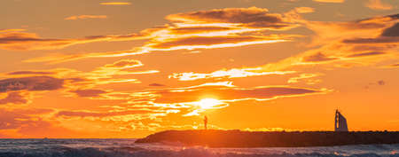 Panorama of a sunset on a dike with a view of the lighthouse of La Grande Motte, southern France...