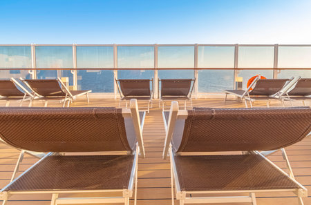 View of lounge chairs facing the sea on a cruise ship.の写真素材