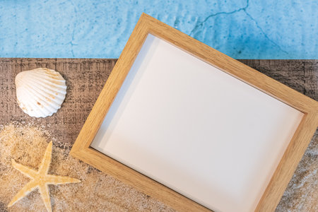 Photo frame without inscription seen from above on a wooden paving above a swimming pool with a starfish. Holiday atmosphere in summer.の写真素材