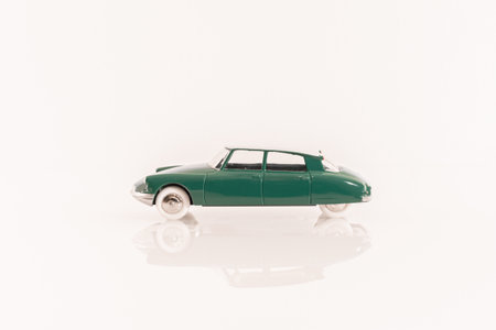 CitroÃ«n DS 19 miniature collector's vehicle in green color with white roof.