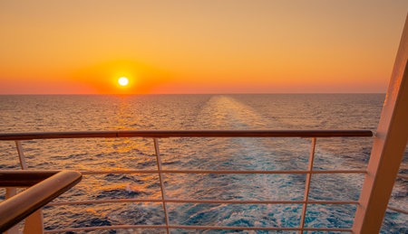 Promenade deck of a cruise ship in navigation with sunset.の写真素材