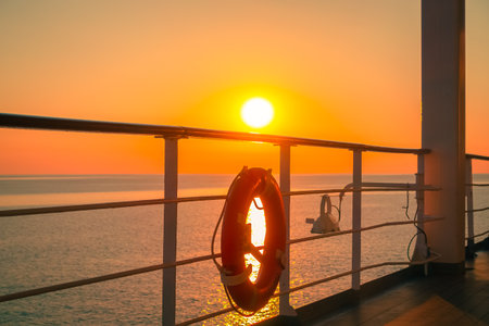 Promenade deck of a cruise ship in navigation with sunset.の写真素材