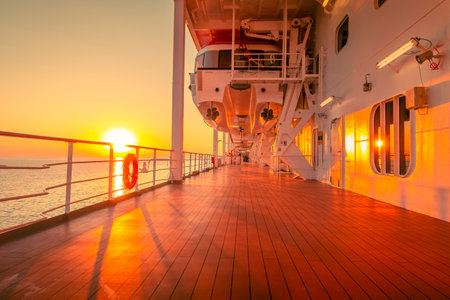 Promenade deck of a cruise ship in navigation with sunset.の写真素材