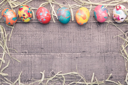 Colorful easter eggs on wooden background with space for your text