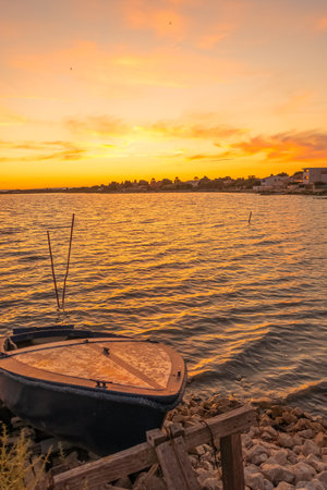 Fishing boat on the lake at sunset, beautiful nature background.の写真素材