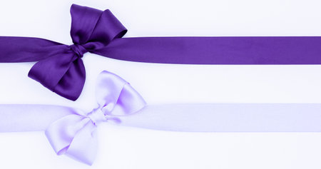 Purple satin ribbons with bow isolated on white background.の写真素材