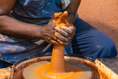 hands of a potter, creating an earthen jar on the circleの写真素材