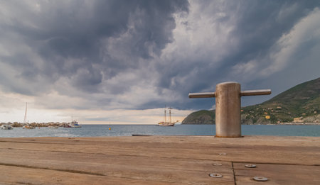 Bollard on the pier with stormy clouds in the backgroundの写真素材