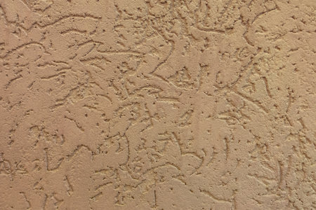 Texture of old wall covered with brown stucco. Abstract background for design.の写真素材
