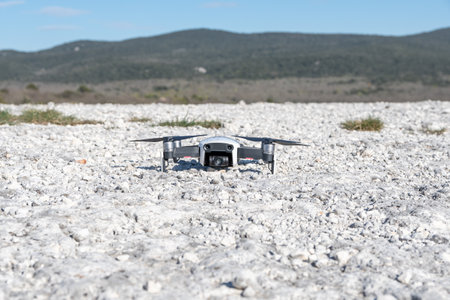 drone quadcopter with digital camera on the white sand beachの写真素材
