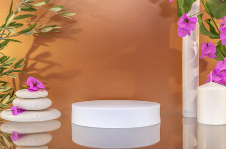 White round podium for product presentation with bougainvillea flowers and candles on brown backgroundの写真素材