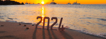 2024 on the beach at sunset. Concept of the new year.