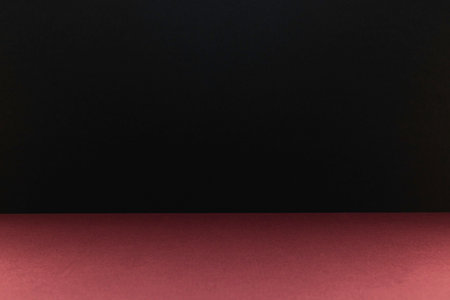 Empty red table with black background and copy space for your text.の写真素材
