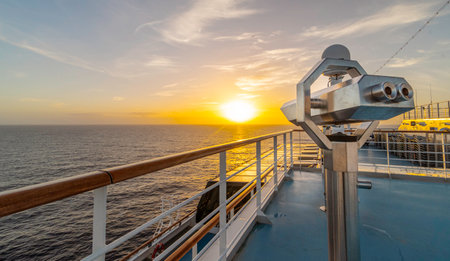 Binoculars on the deck of a cruise ship at sunsetの写真素材