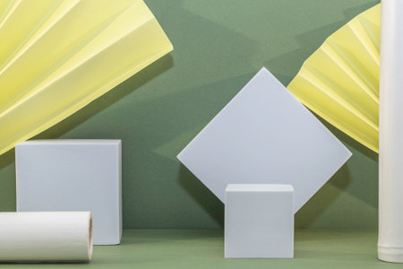 Geometric shapes with paper sheets on green background. Minimalism concept.の写真素材