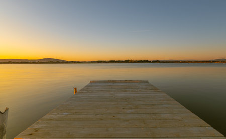 Wooden jetty at sunset in Camargue, France.の写真素材