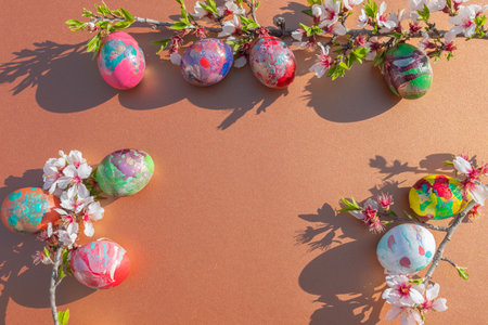Easter eggs and spring blossom on brown background with copy spaceの写真素材