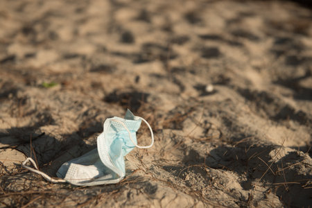 Blue surgical mask on the beach.Mask for  protection.