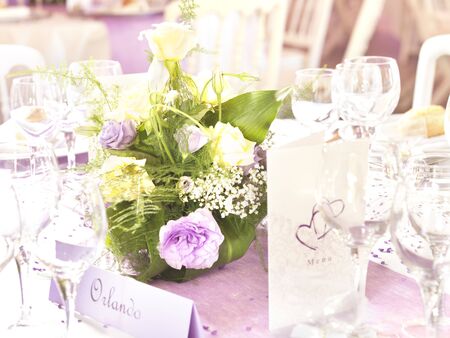 Wedding decoration with flowers and place card in yellow and violetの写真素材