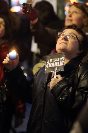 A woman is holding a typical sign during the Paris Rally 2015-01-11のeditorial素材