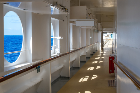 Promenade deck of a cruise ship on a Sunny day with views of the sea horizon.の写真素材
