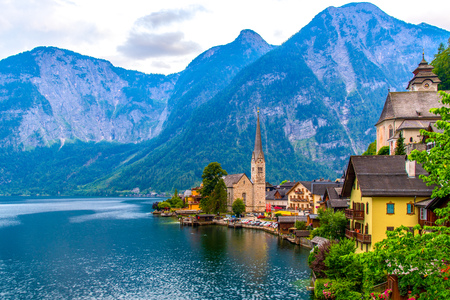 View of the Alpine town of Hallstatt on the shore of a mountain lake at sunsetの写真素材