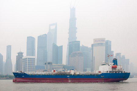 SHANGHAI, CHINA - JUN 2013: Cargo ship sails against the backdrop of skyscrapers of Shanghaiのeditorial素材
