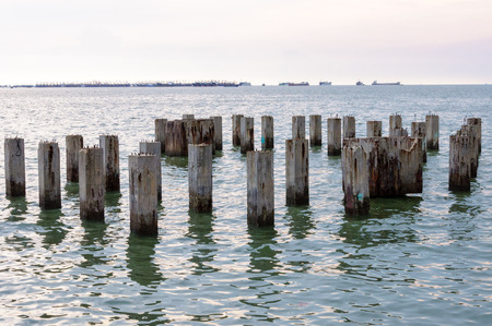 BEIHAI, CHINA - JUN, 2013: Piles sticking out of the water abandoned pier.のeditorial素材
