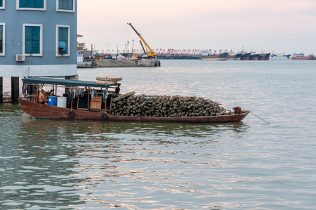 BEIHAI, CHINA - JUN, 2013: Heavily loaded old Chinese boatのeditorial素材